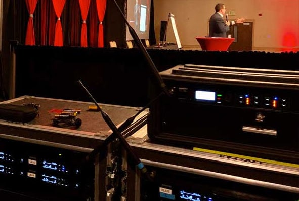 Conference AV staging, lighting, and production setup in large venue